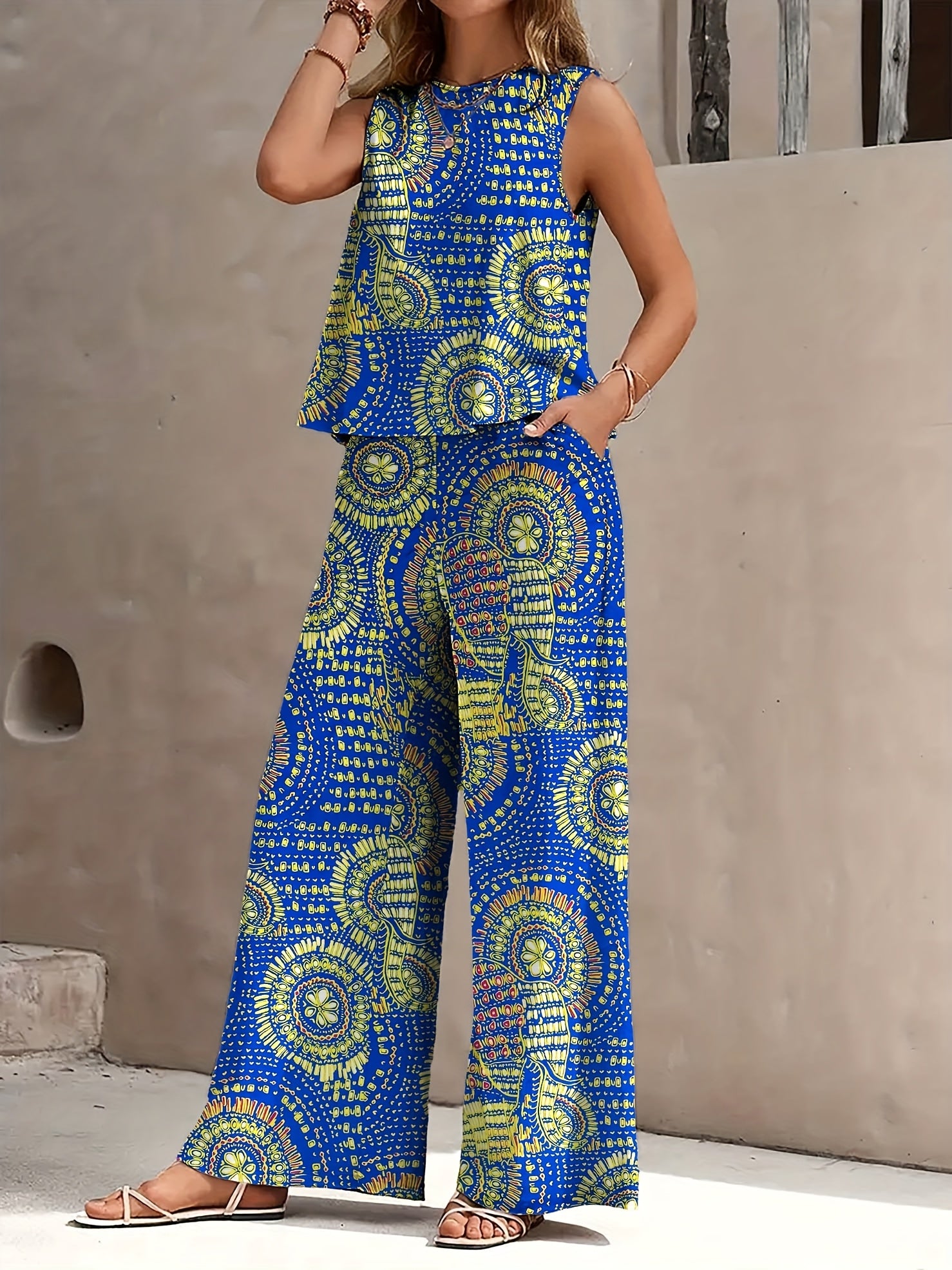 A And Textured Imitation Suit with Hand-Painted Totem Prints. It Includes a Round-Neck Sleeveless Top And Long Pants with Side Pockets. This Easy And Stylish Suit Is Perfect for Daily Commuting